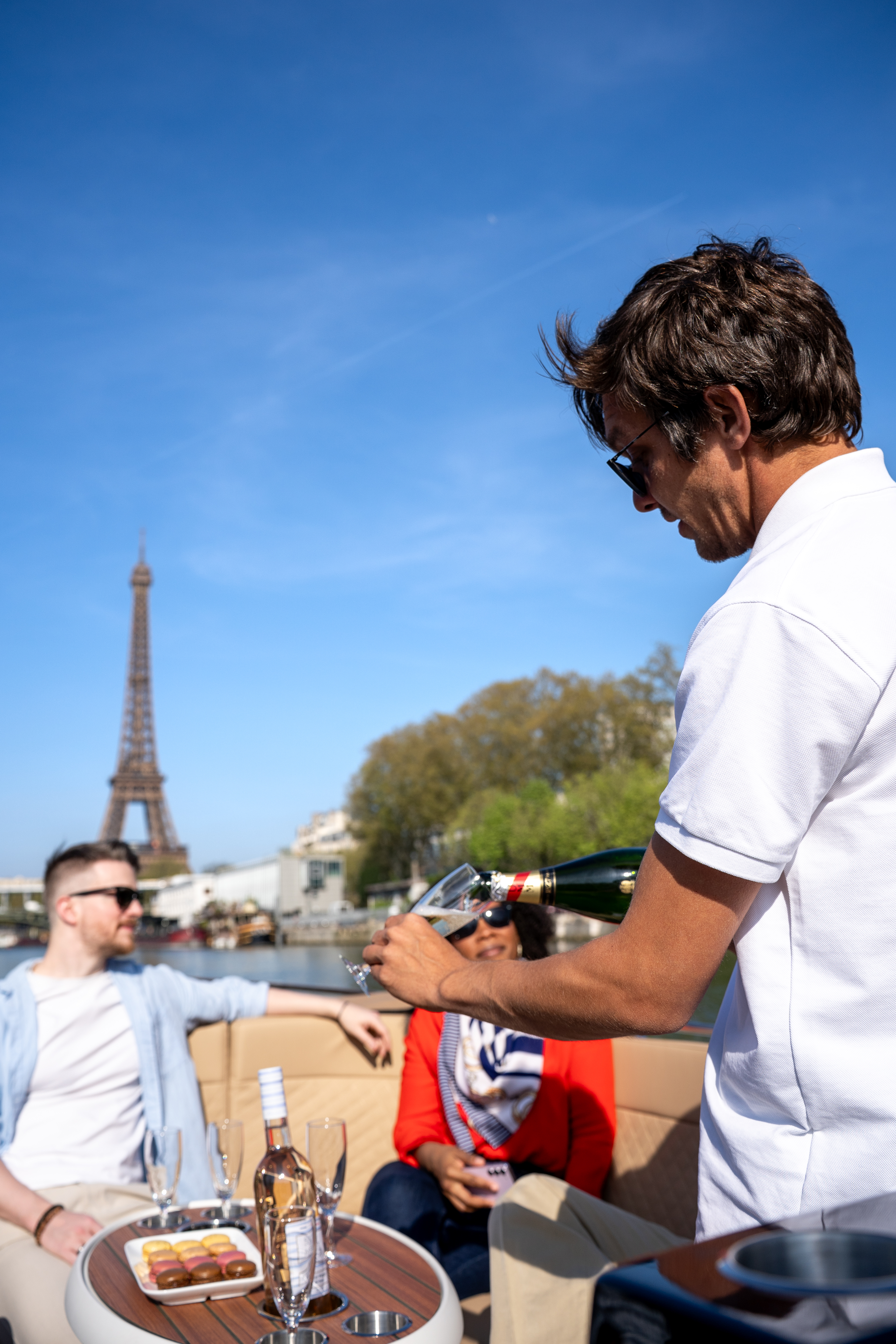 Pilot / guide serving champagne on a private boat with the eiffel tower in the background